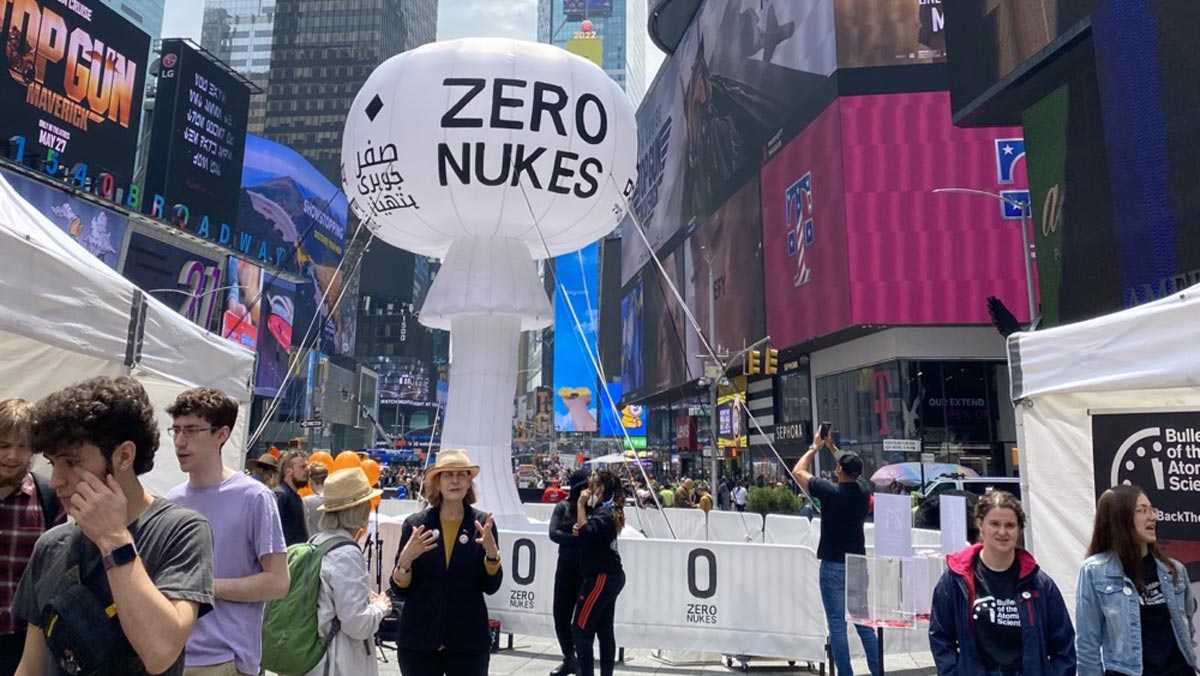 People gather around a large inflatable structure in Times Square, displaying 