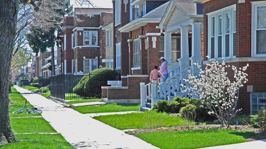 row of brick houses with green grass