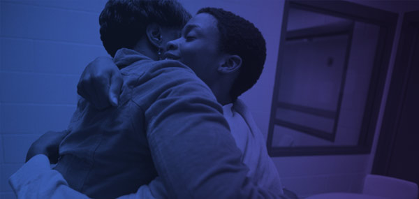 Womanandteenageboyhugging