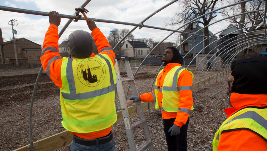 WorkersBuildingAGreenhouseFrame