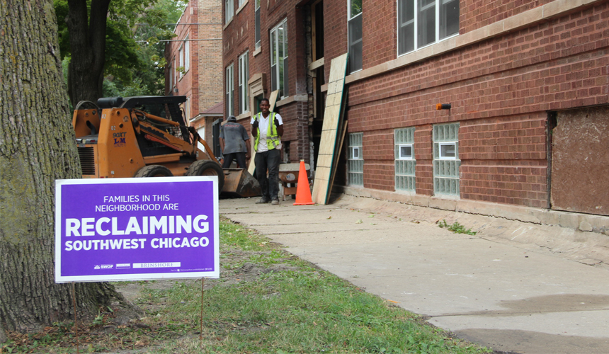 ReclaimingSouthwestChicagoSignAndConstructionWorkerRehabbingABuilding